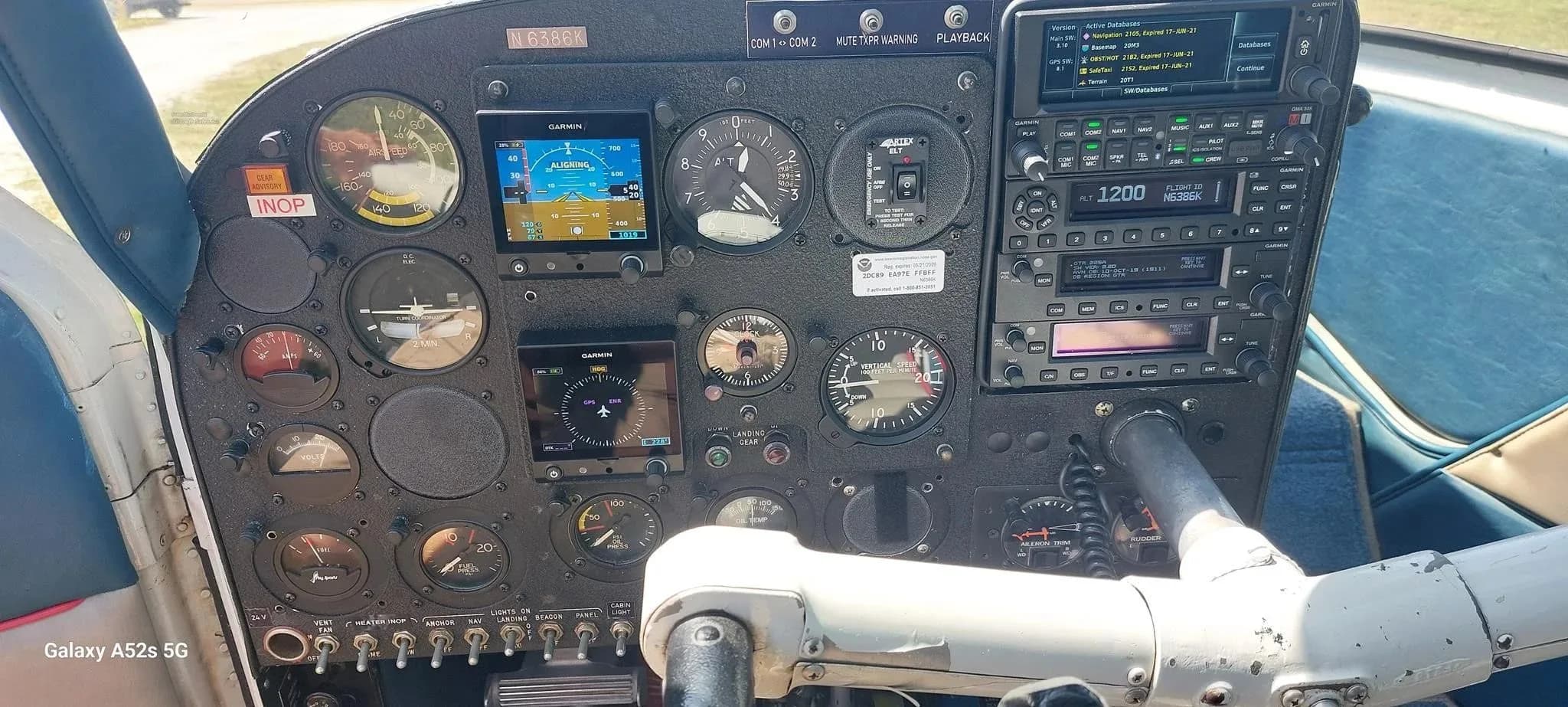 The instrument panel of the N6386K aircraft, featuring multiple gauges and modern Garmin displays.
