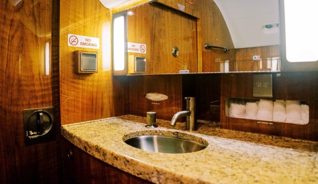 The aircraft's interior features couches and wood trim.
