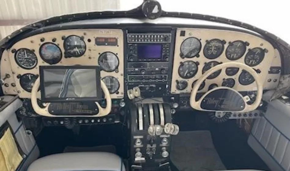A full view of the aircraft's cockpit, featuring a detailed instrument panel, dual yokes, and throttle quadrant.