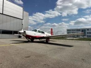 Front view of the D-ETIB aircraft with a red and white paint scheme parked on the tarmac.