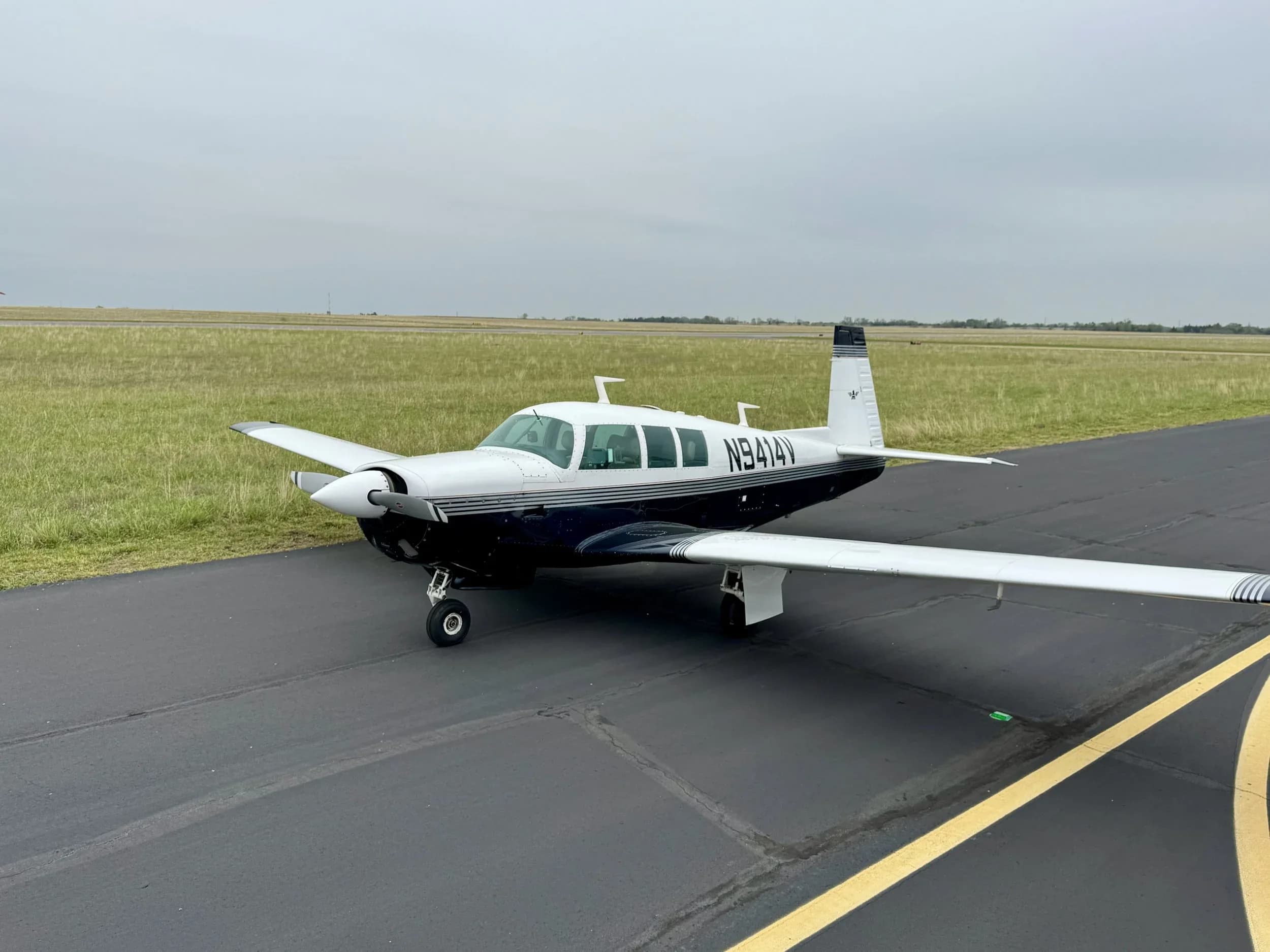 A Beechcraft Bonanza aircraft with registration N9414V is parked on the tarmac.