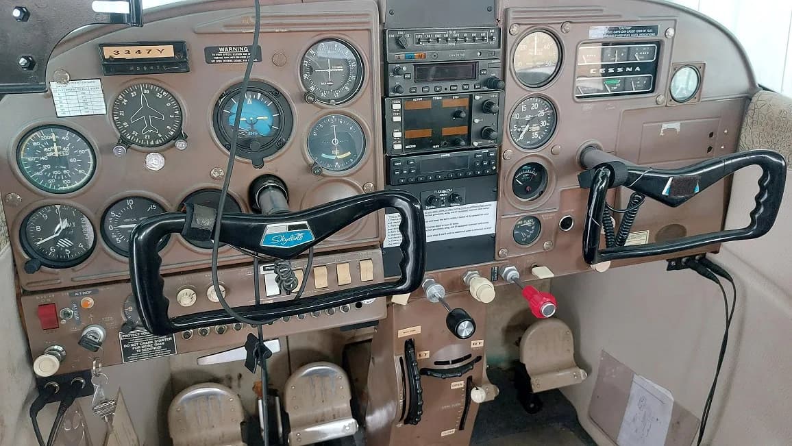 The cockpit of an aircraft, showing the instrument panel and controls.