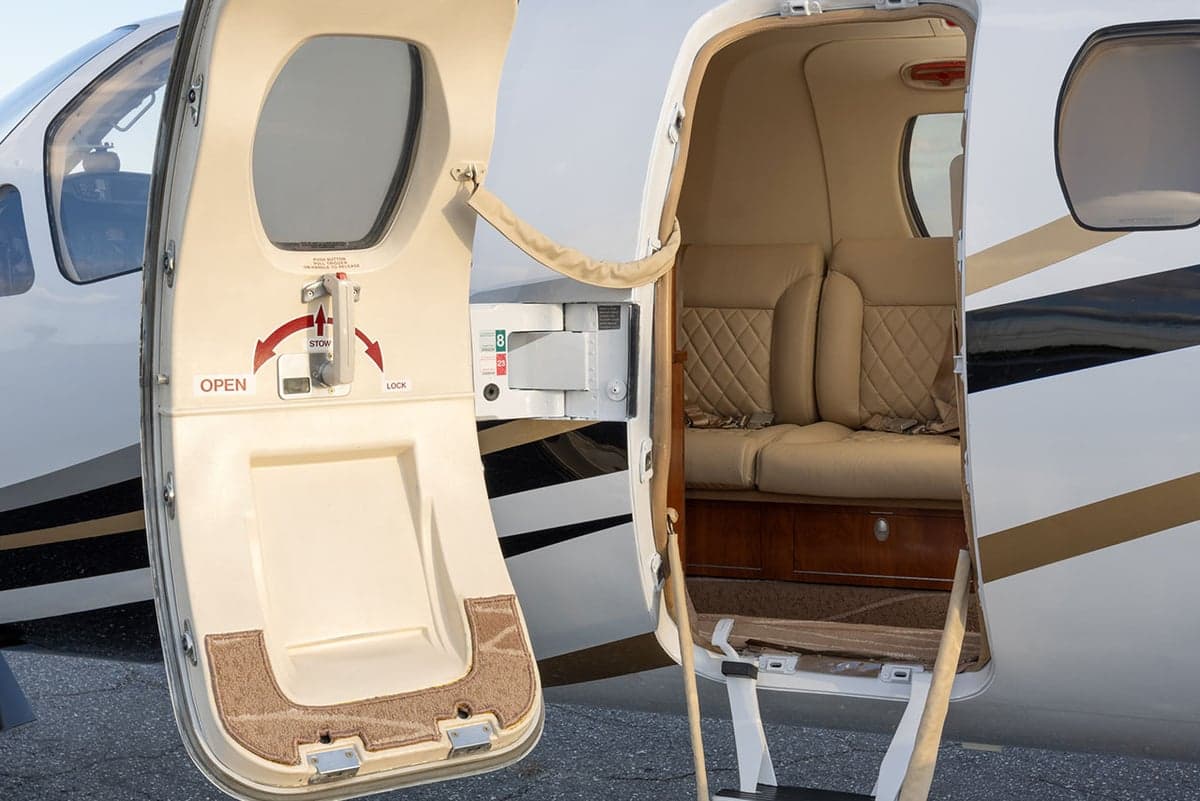 View of the aircraft door open, showing the interior and steps.