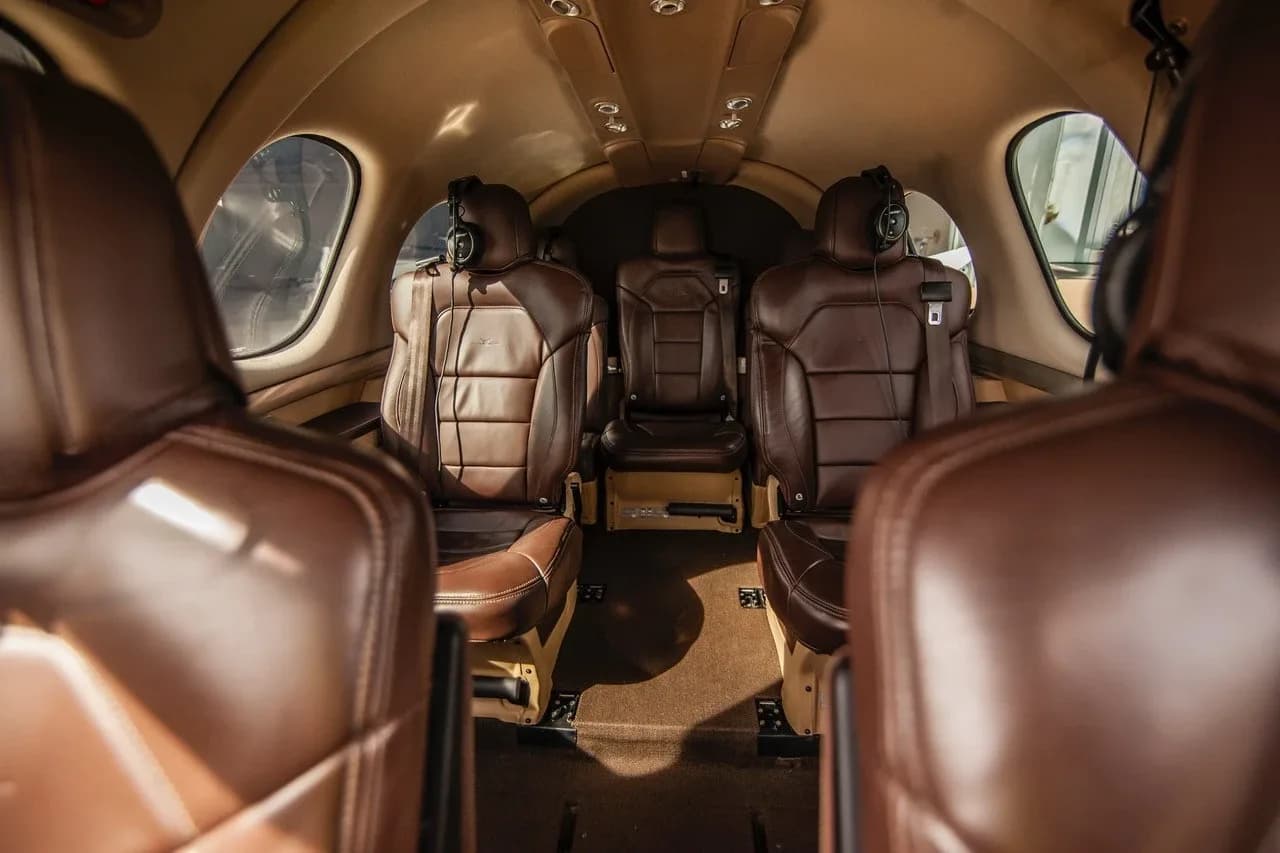 The brown leather passenger seats in the cabin of a Cirrus Vision Jet, viewed from the rear.