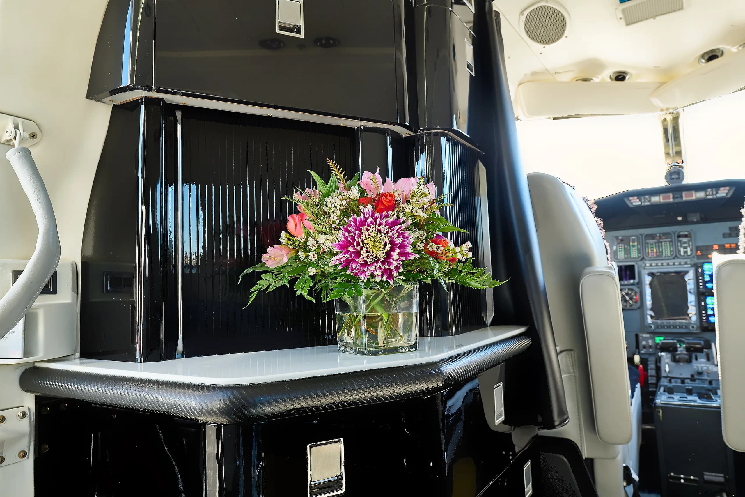 View of the aircraft cockpit with a bouquet of flowers in the foreground.