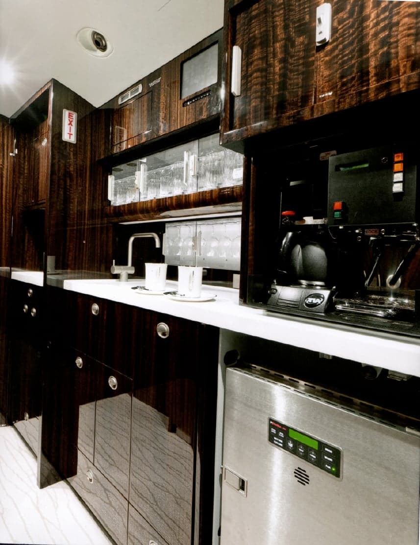 View of the galley area with coffee maker and storage.