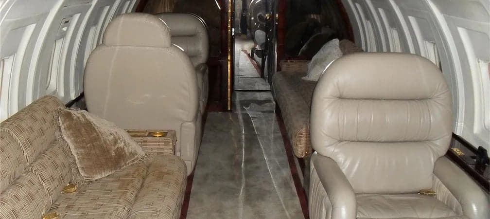 Interior of the aircraft featuring leather seats and a sofa.