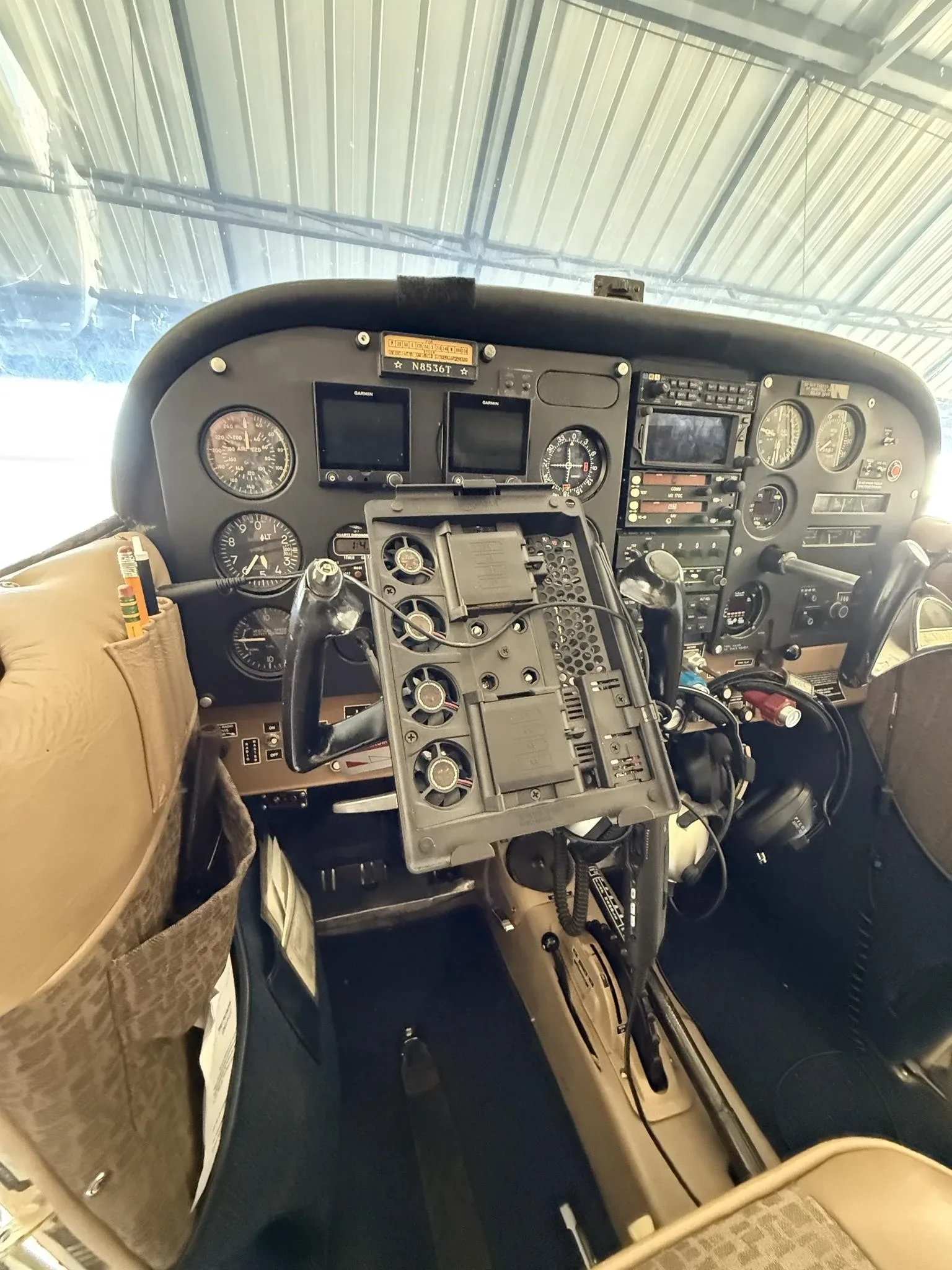 View of the aircraft's instrument panel with gauges, avionics, and a yoke-mounted tablet holder.