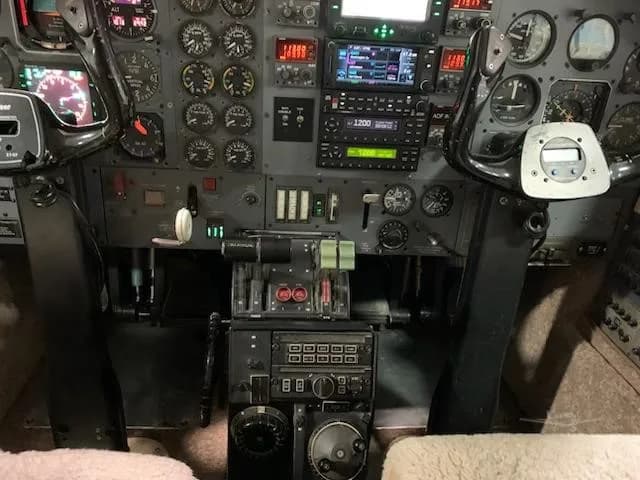 A view of the lower center console and instrument panel, showing engine controls and radio stack.