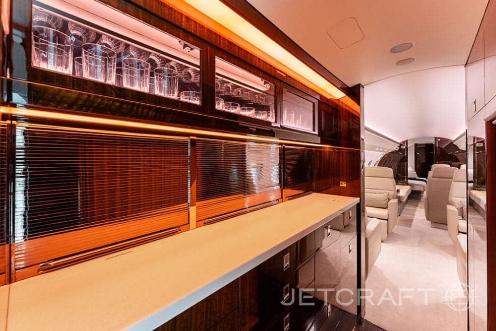 Interior view of a Bombardier Global Express business jet with a bar area.