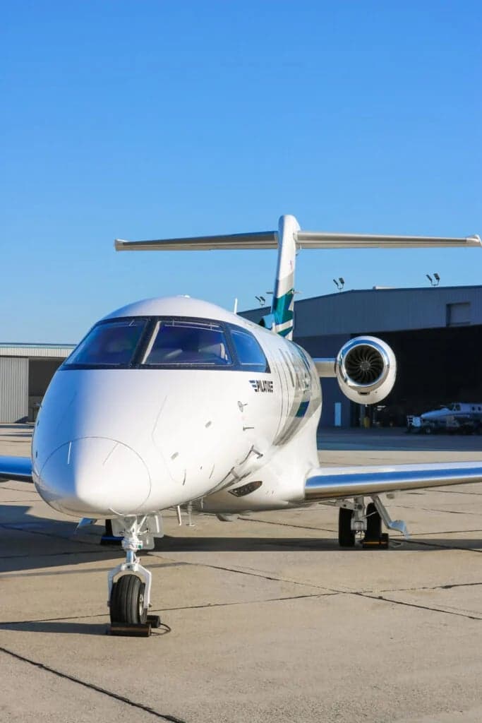 Front view of the Pilatus PC-24 N357LT with a white and teal paint scheme.