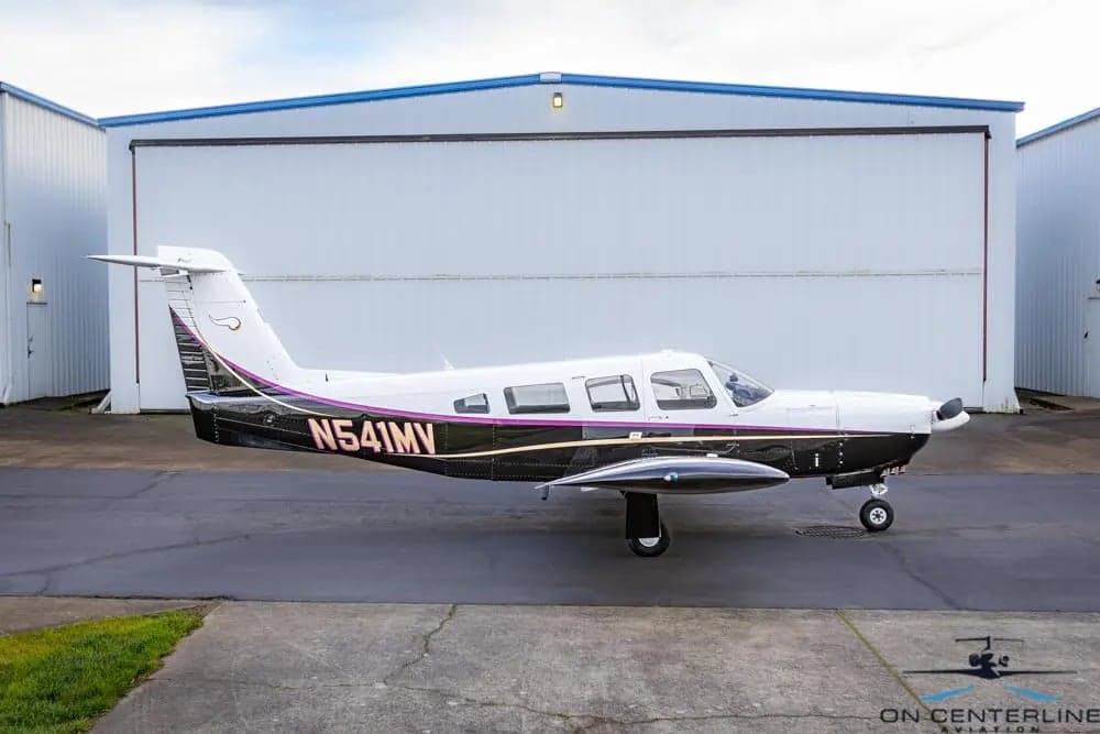 Side view of a Piper PA-32R-301 Saratoga SP, registration N541MV, parked on the tarmac.