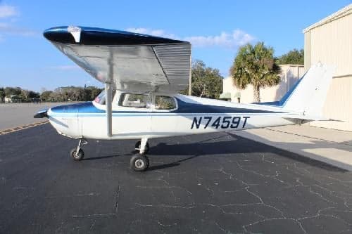 Side view of Cessna 150 aircraft N7459T on the tarmac.