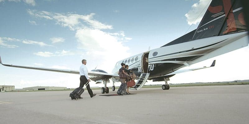 King Air 260 on the tarmac with passengers boarding.