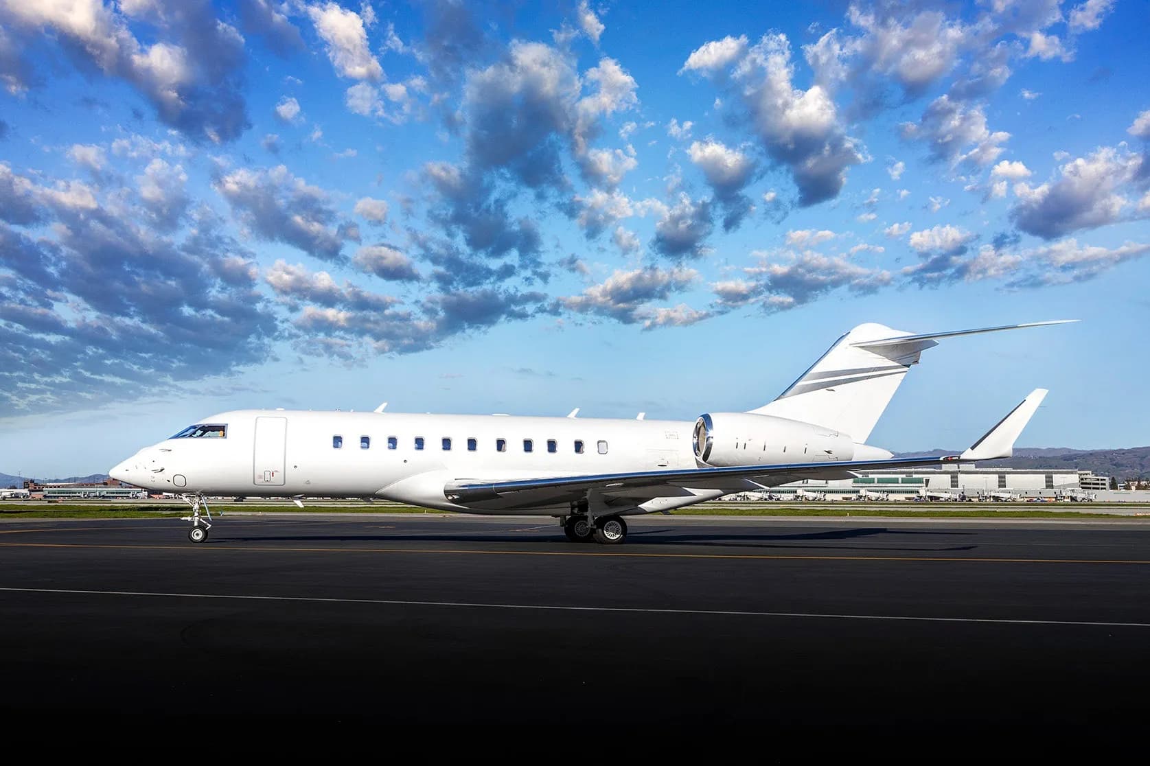 A white Bombardier Global Express on the tarmac.