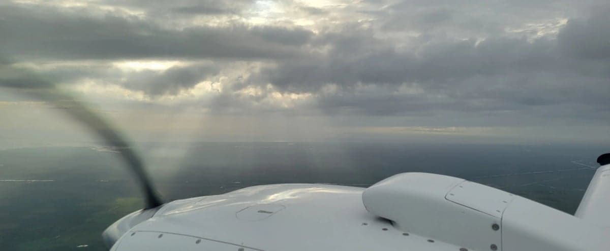 View from the cockpit of the aircraft, showing the engine and propeller.