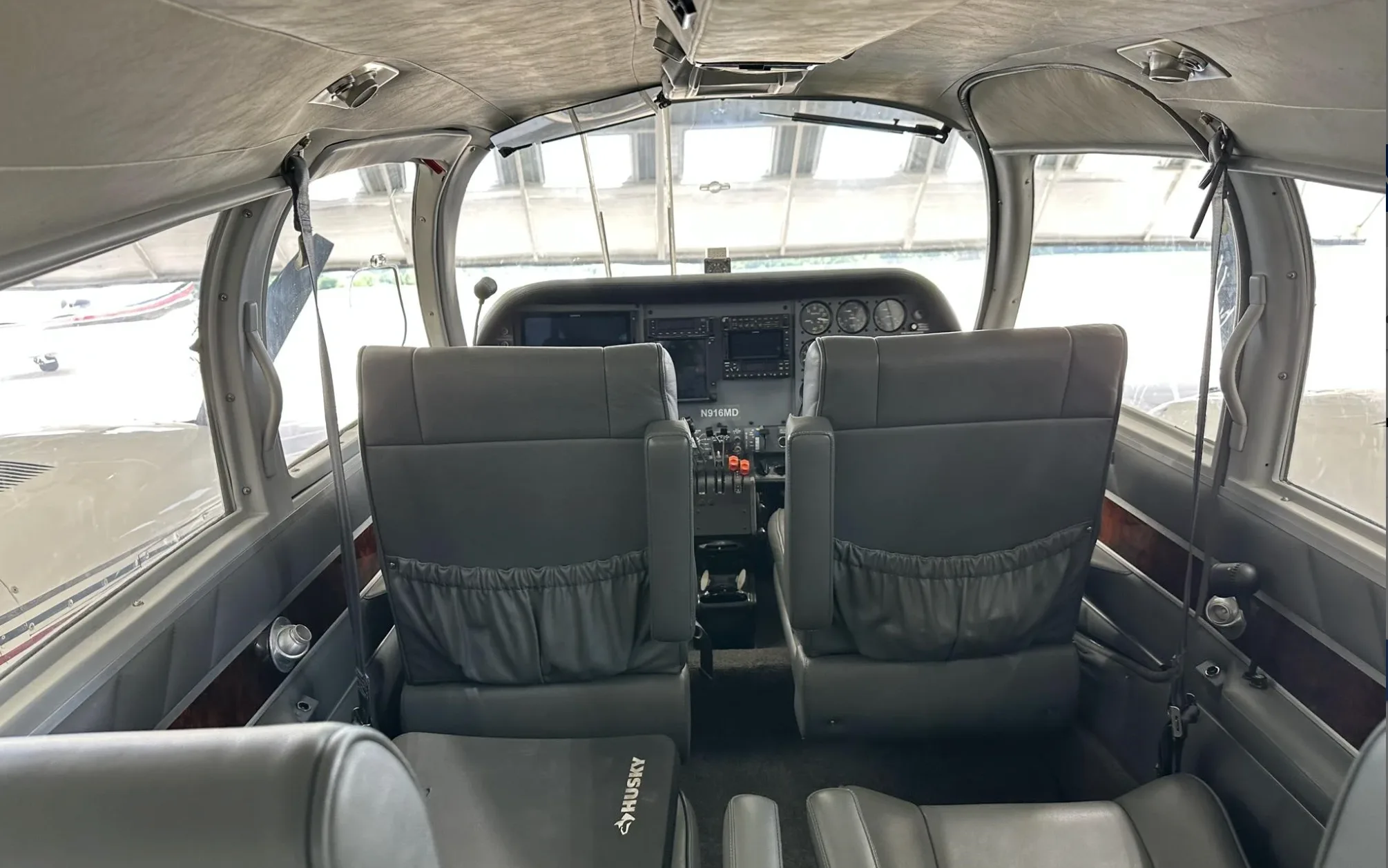 A view from the cabin looking into the cockpit of the N916MD aircraft, showing the instrument panel and seats.