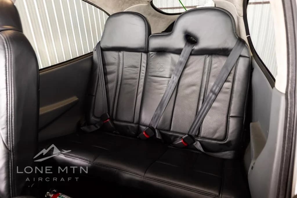 The black leather rear seats of the Cirrus SR22 aircraft cabin.