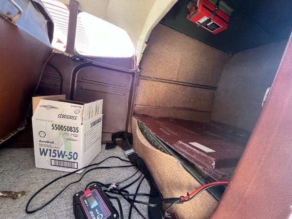View of the Cessna Skywagon 180's rear cargo area with various items inside.
