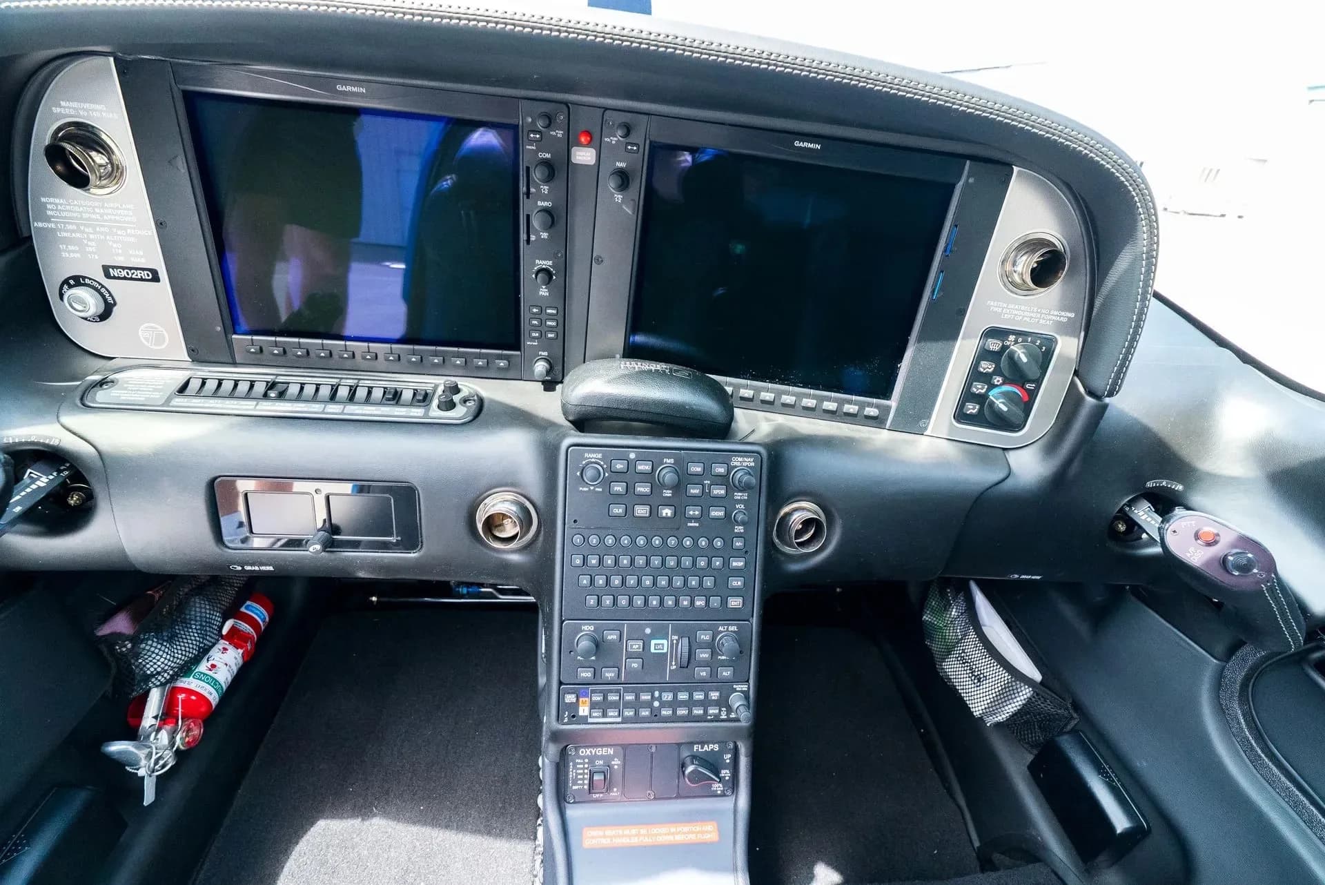 A close-up view of the Garmin avionics and control panel in the cockpit of a Cirrus SR22 aircraft.
