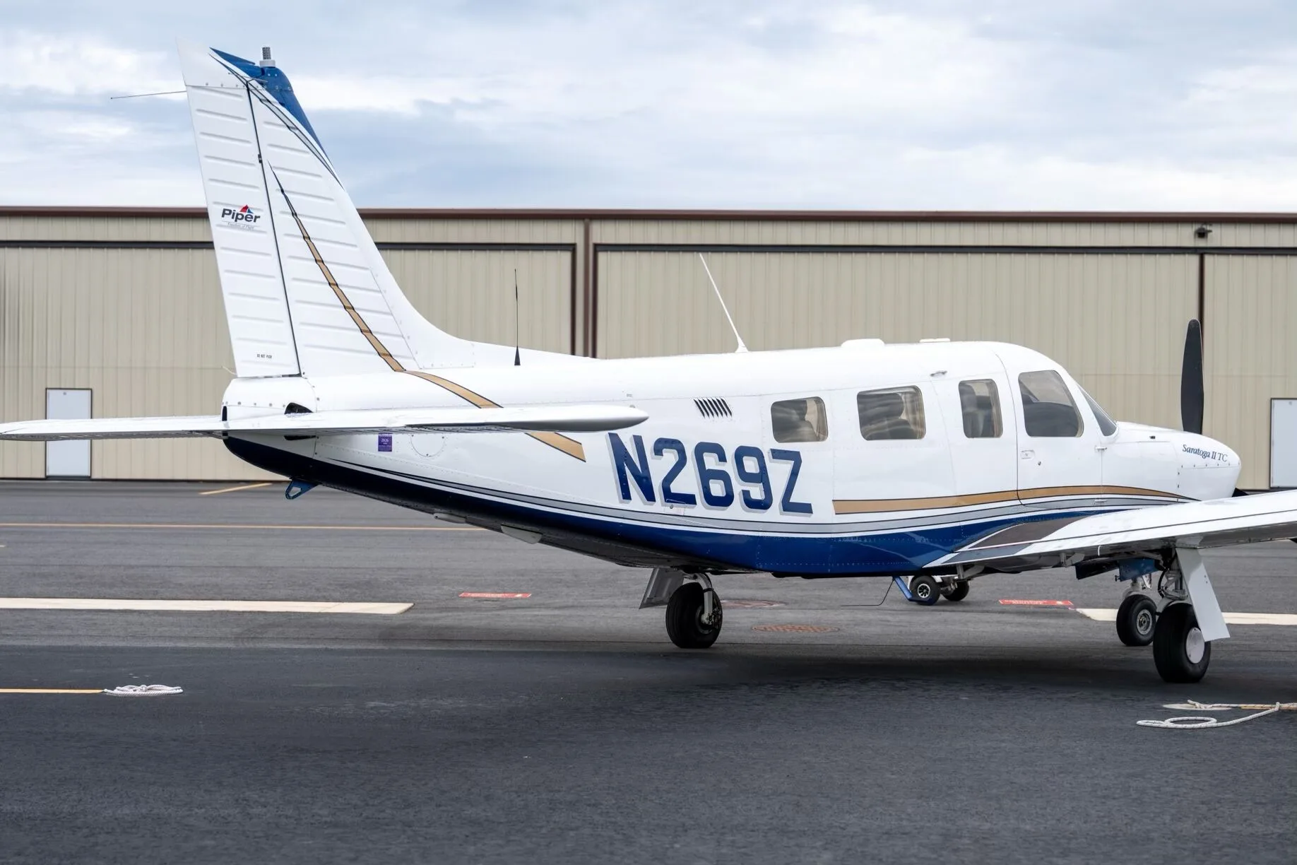 A close-up view of the rear fuselage and tail of a white Piper Saratoga II TC, showing the N269Z tail number and Piper logo.