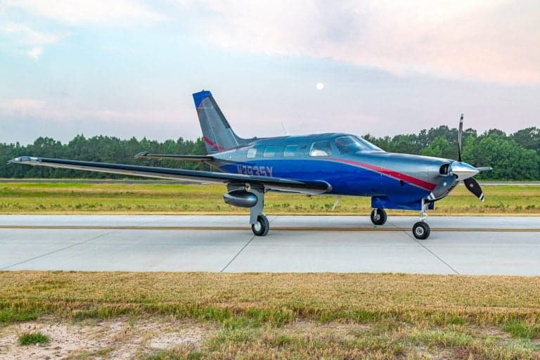 Piper Mirage N3935Y on the runway, full side view.