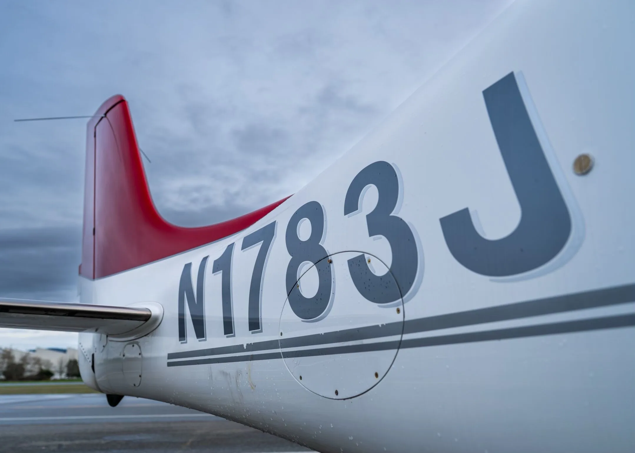 A close-up view of the N1783J registration number on the white fuselage and red tail of the aircraft.