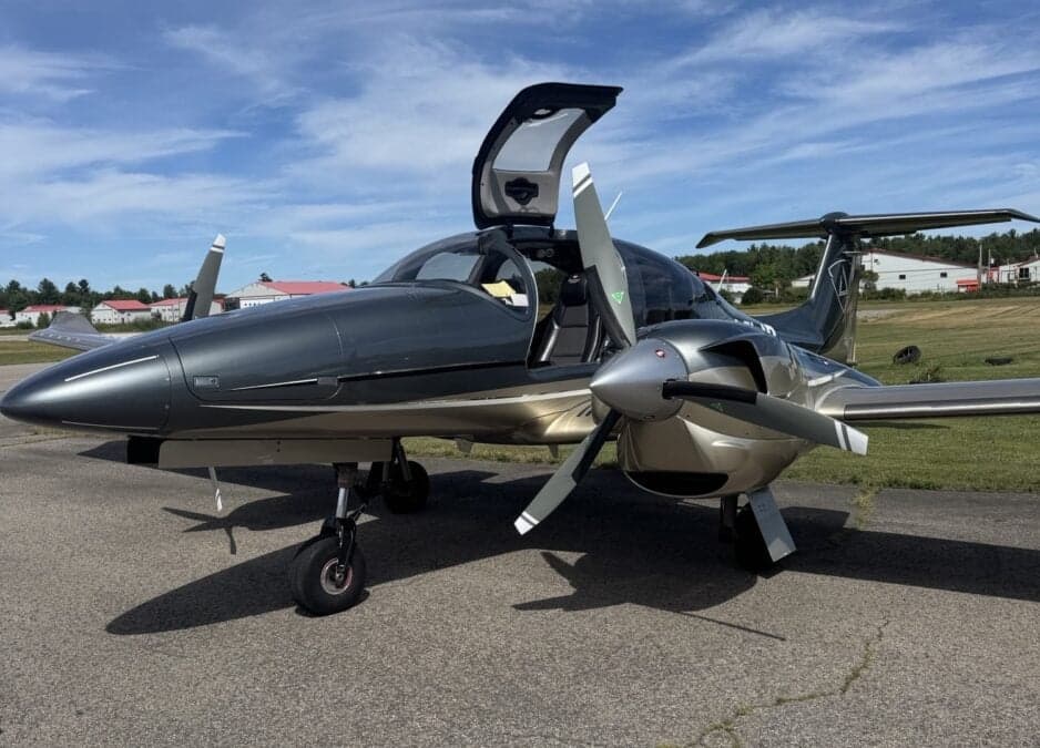 Diamond DA62 aircraft with open gull wing door on the tarmac.