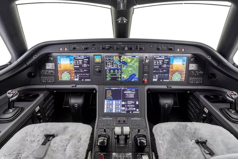 The instrument panel and controls of an Embraer Phenom 300E cockpit.