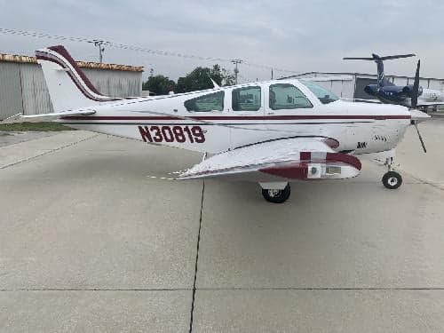 Side view of a Beechcraft Bonanza with tail number N30819 on the ramp.