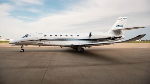 Side view of a white Cessna Citation Latitude on the tarmac.