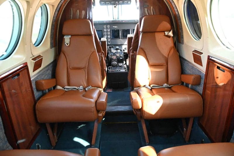 The interior of a Beechcraft King Air features leather seats and wood trim.