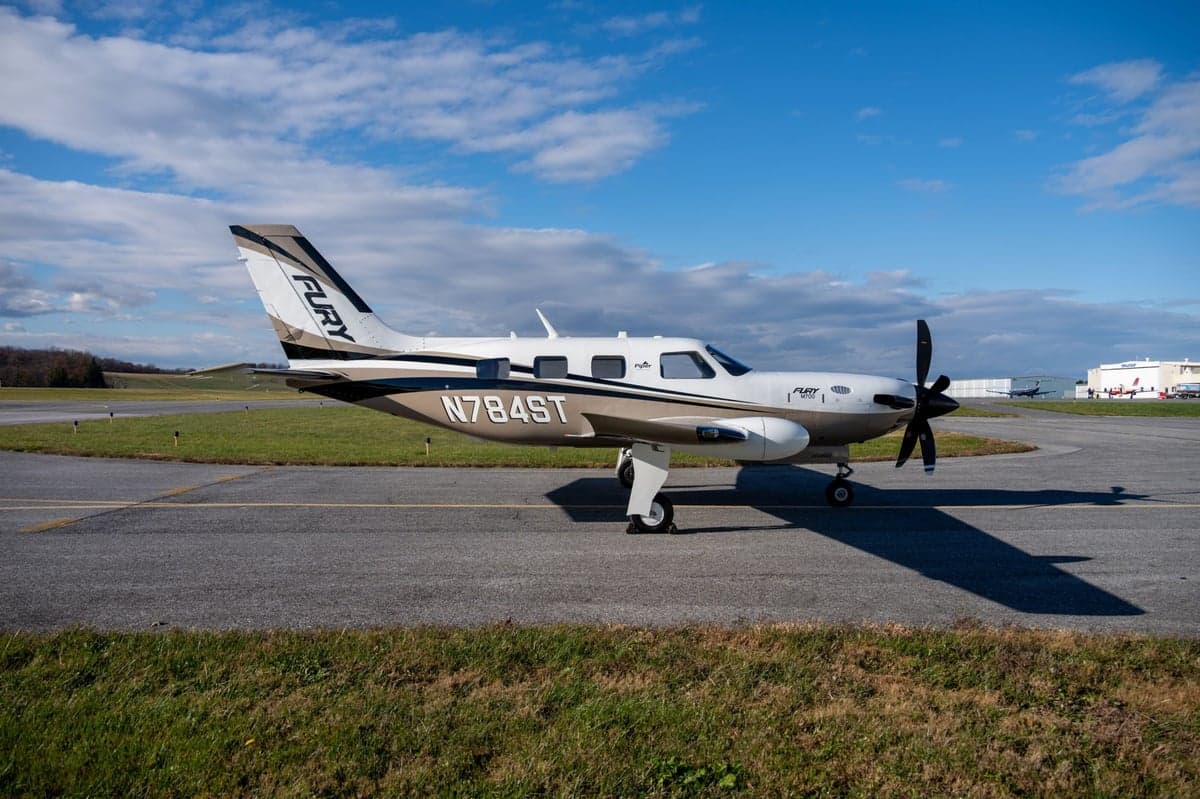 Side view of the Fury M700 aircraft with tail number N784ST on the tarmac.