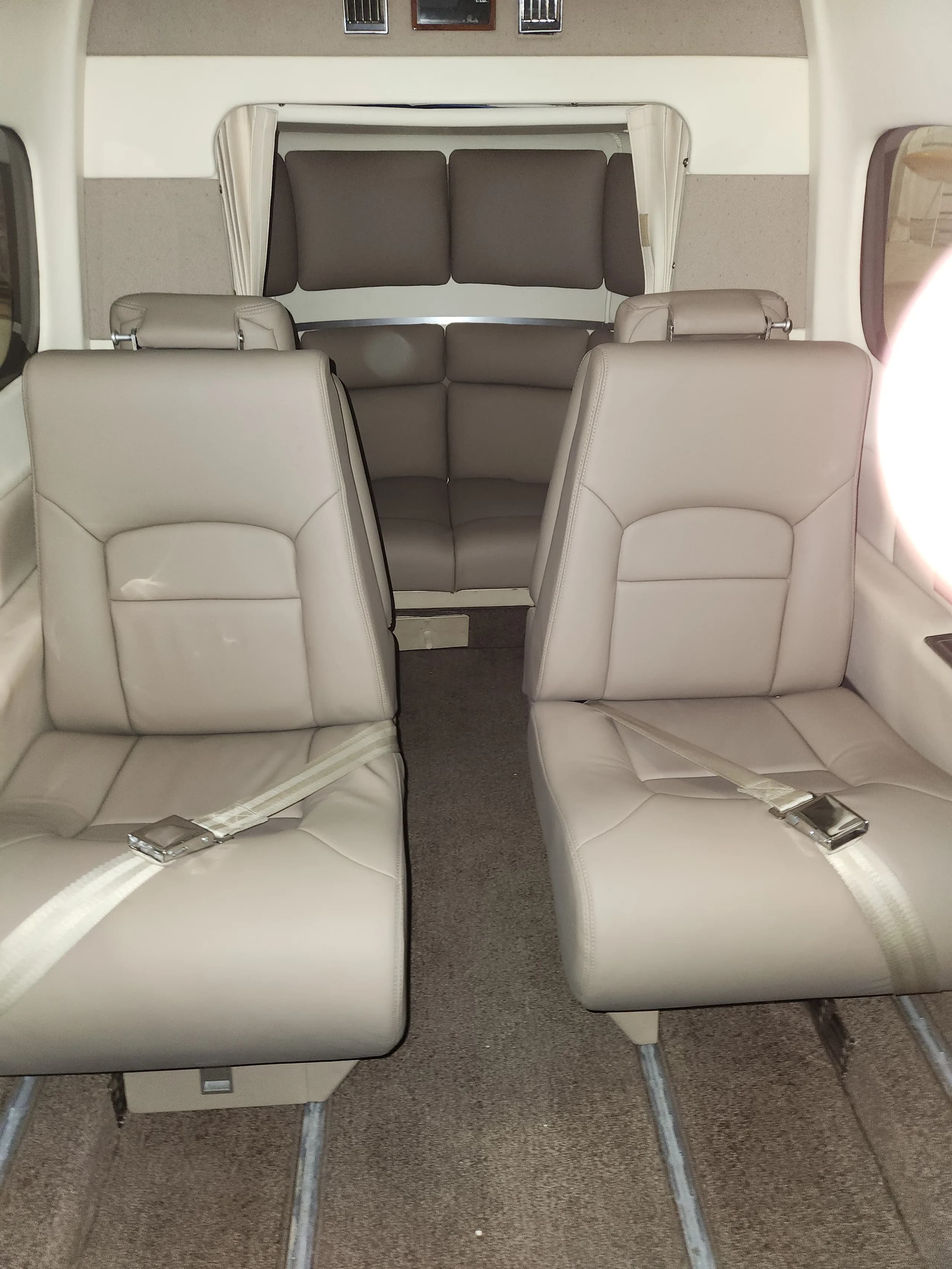The interior of the Commando aircraft features tan leather seats.