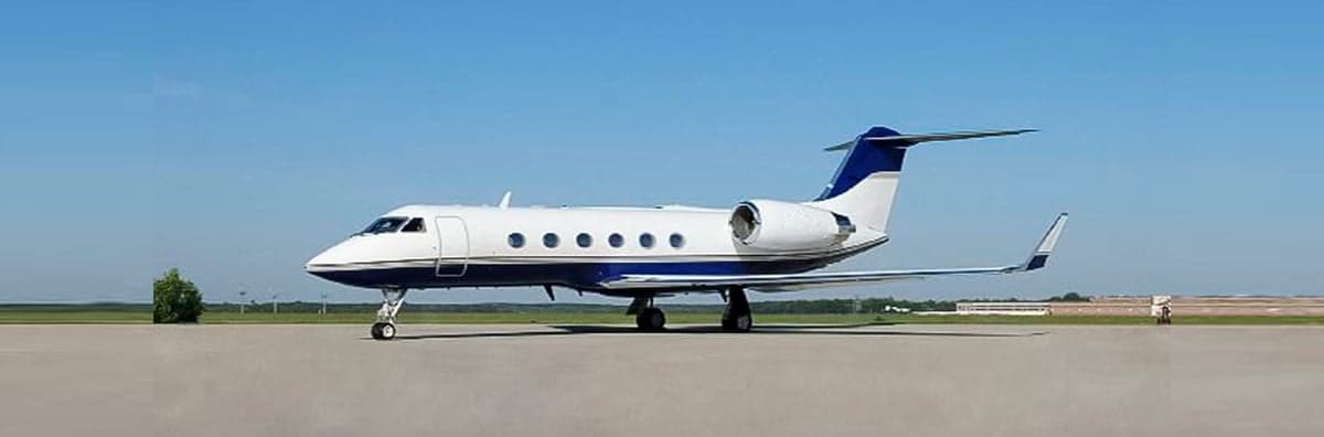 A Gulfstream business jet is parked on the tarmac.