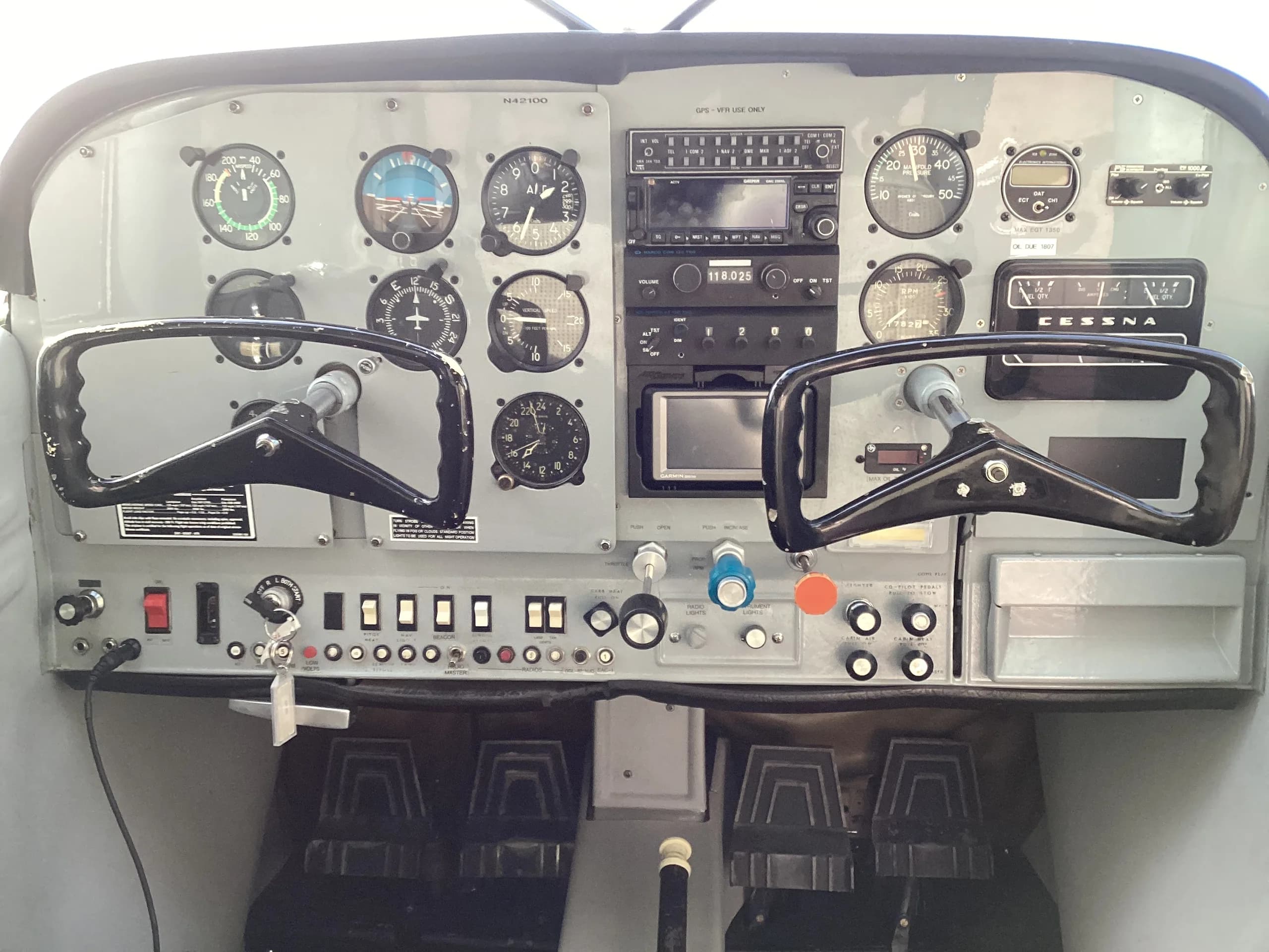 Close-up view of the Cessna 172 cockpit instrument panel with dual yokes and analog gauges.