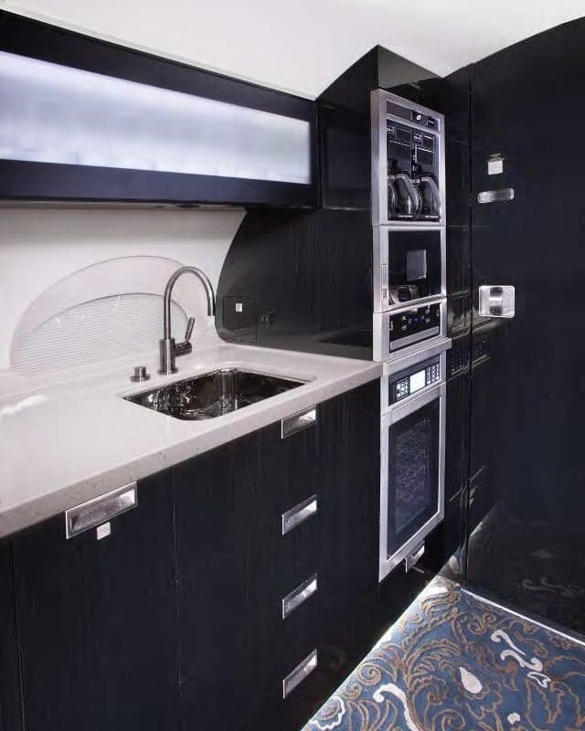 Galley area with sink, faucet, and appliances.
