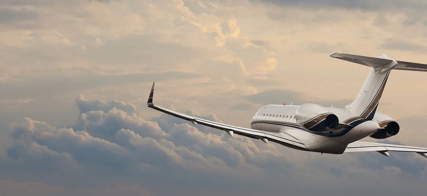 A business jet flying through the clouds.