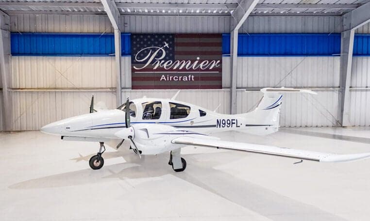 A Diamond DA62 aircraft with tail number N99FL is parked in a hangar.
