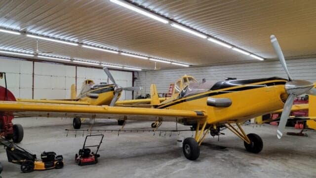 Close-up of a yellow and black aircraft with the registration number N9646A in a hangar.
