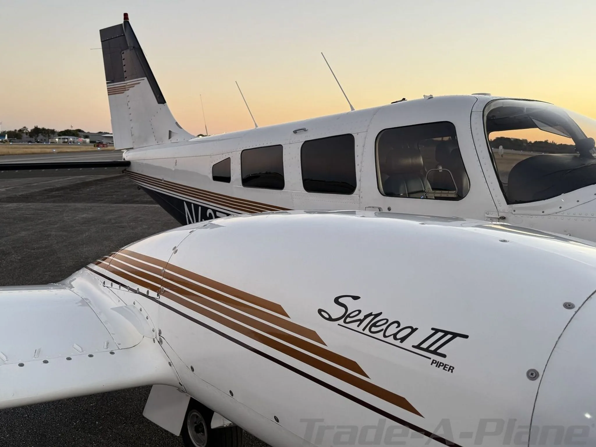 A close-up of the Piper Seneca III's engine cowling and rear fuselage, showing the 'Seneca III Piper' text and N-number.