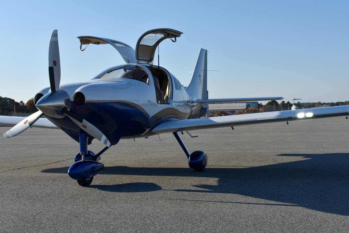 Side view of the white and blue Cessna aircraft N915ML on the tarmac.
