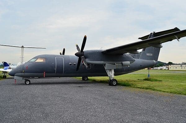 A gray turboprop aircraft parked on the ramp.