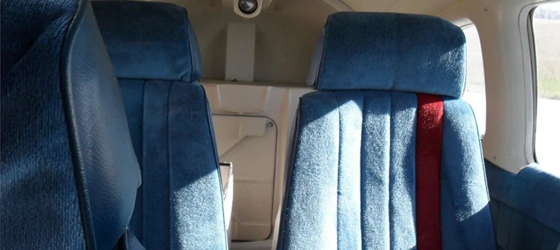 View of the aircraft's blue upholstered seats.
