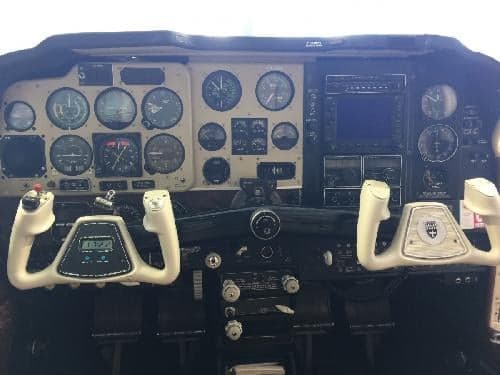 The cockpit features a full instrument panel and white yokes.