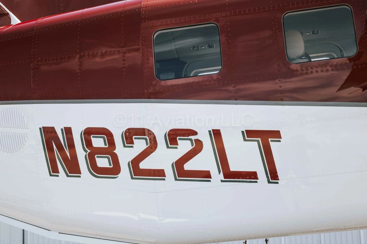 A close-up view of the red and white fuselage showing the registration N822LT.