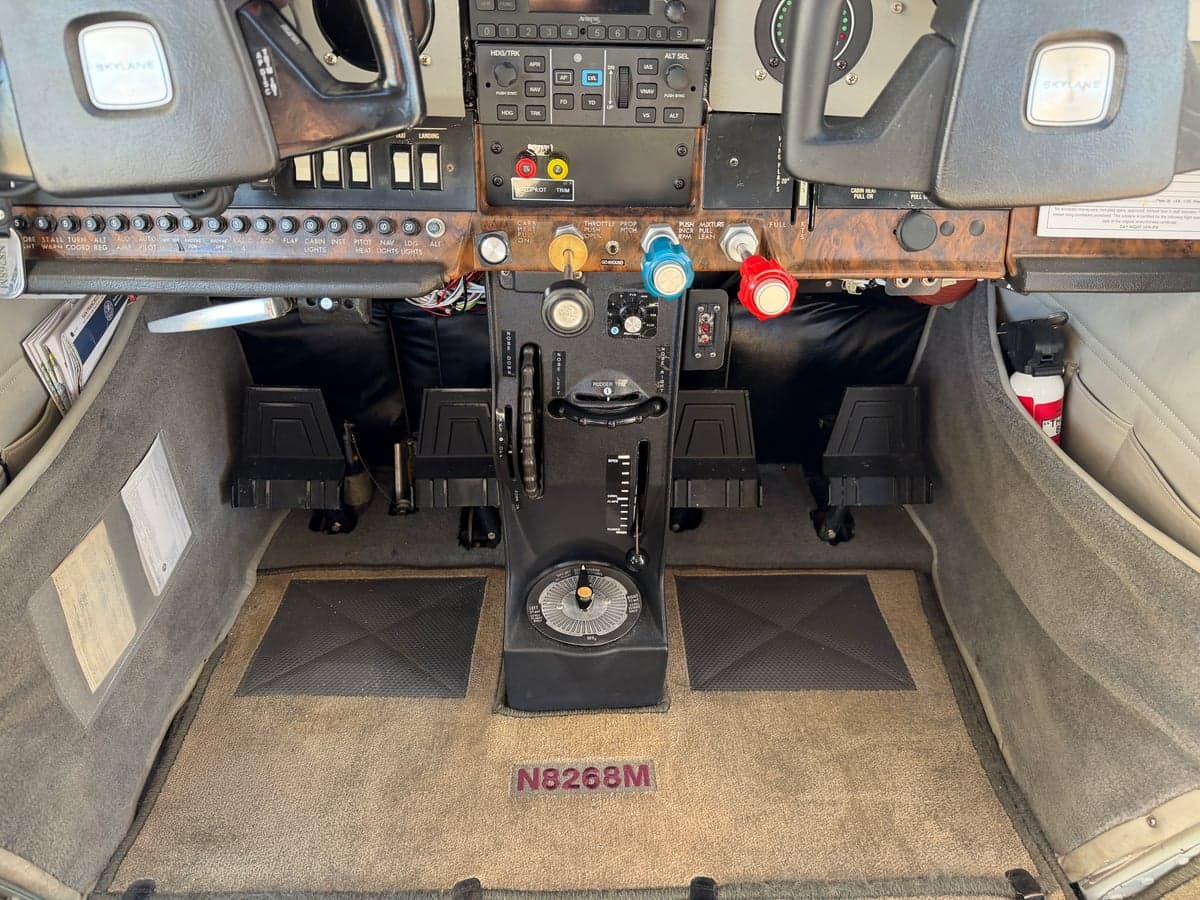 The lower section of the N8268M aircraft's cockpit, including the rudder pedals and control column.