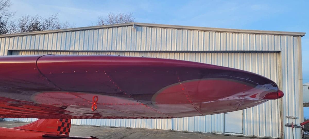 Close-up of the Cessna 195 wingtip and navigation light.