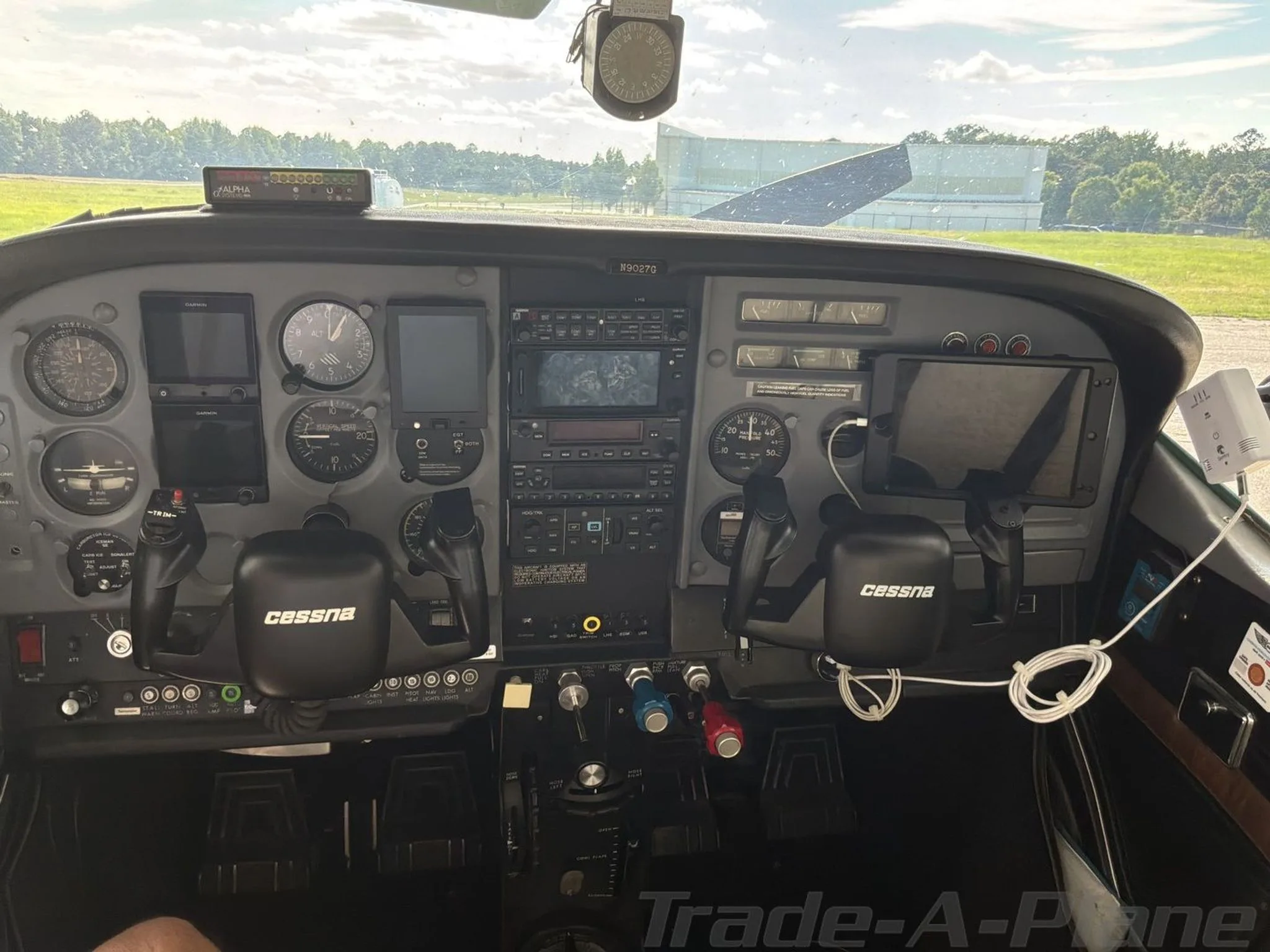 The cockpit of a Cessna 182N Skylane, showing the instrument panel with analog gauges and modern avionics.