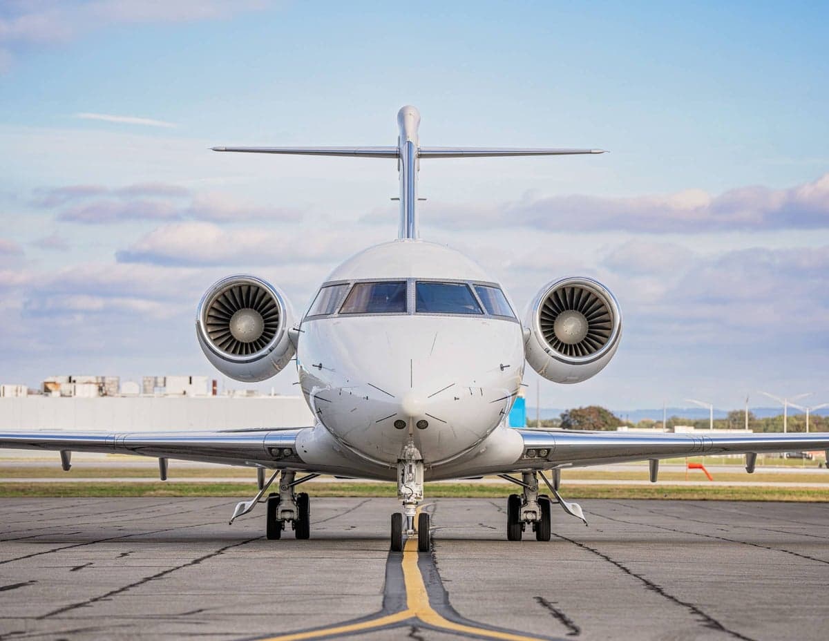 Front view of a Challenger aircraft on the tarmac.